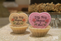 Custom made cookie that says Mazal Tov Shana and Avi